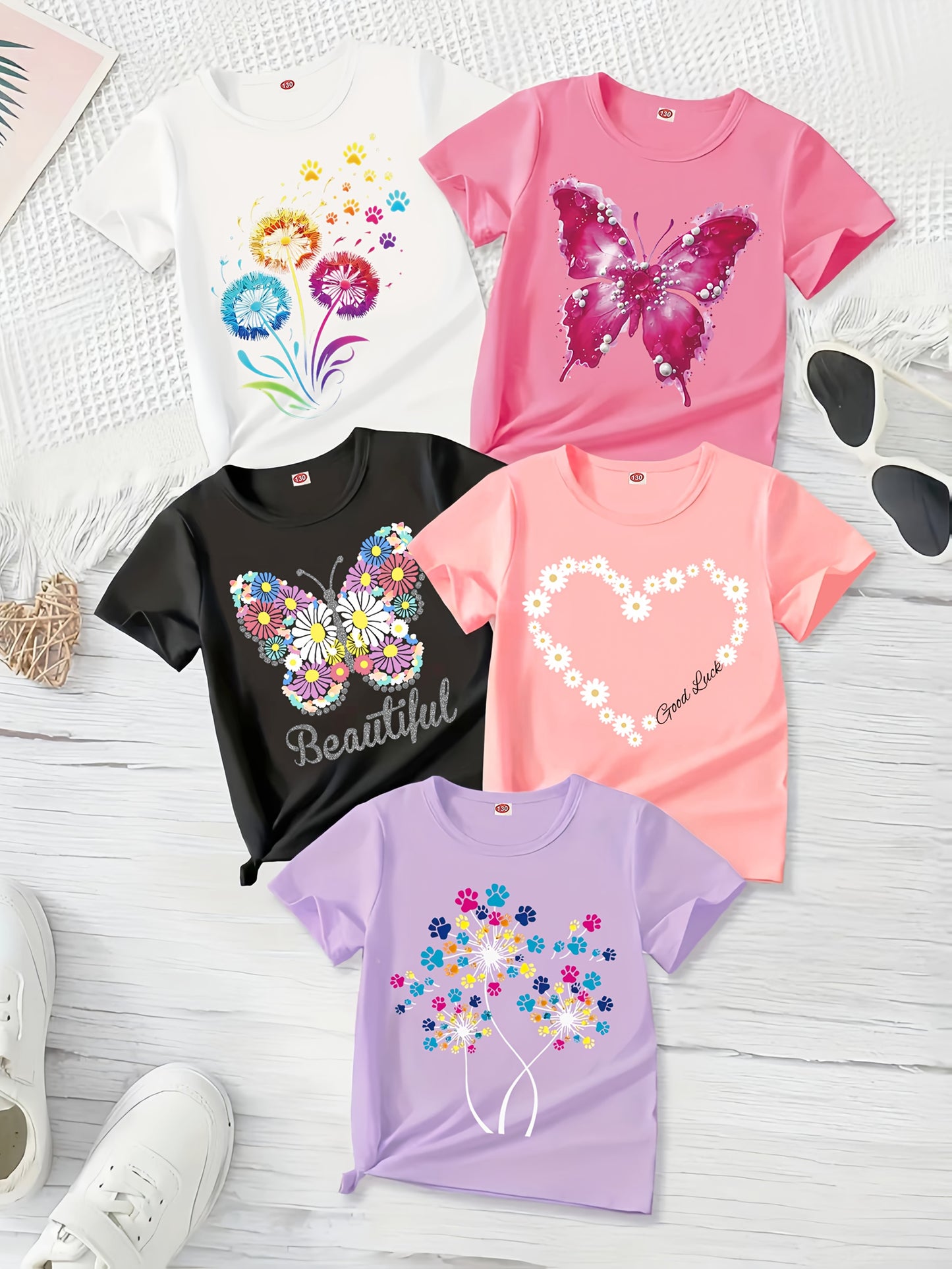 A Set of 5 Sweet And Cute Short-Sleeve T-Shirts for Girls, Featuring Beautiful Prints of Butterflies, Dandelions, And Floral Heart Designs. These Comfortable Casual Summer Tops Have a Regular Fit And Moderate Elasticity