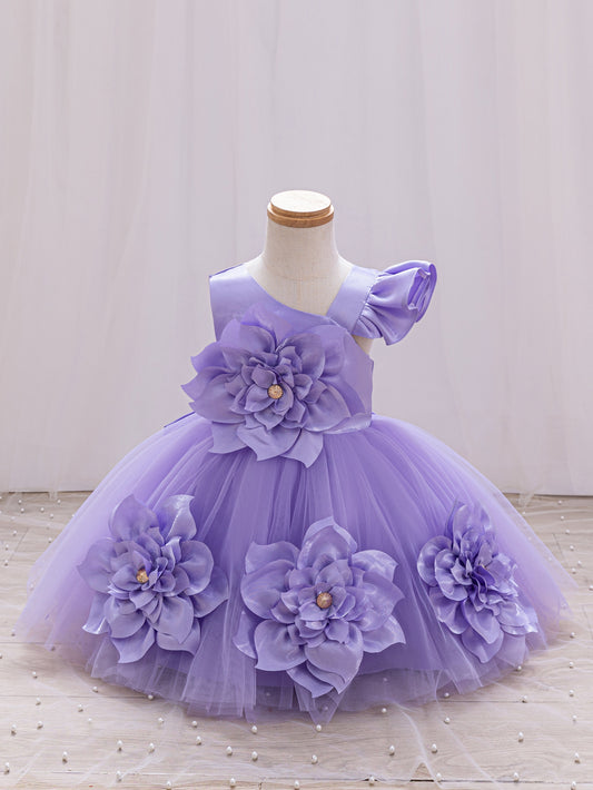 A children's formal dress. It has asymmetric shoulder sleeves, a upper body, and a fluffy tulle skirt decorated with large flowers in the same color. Gorgeous and cute, suitable for dinners, parties and other occasions.
