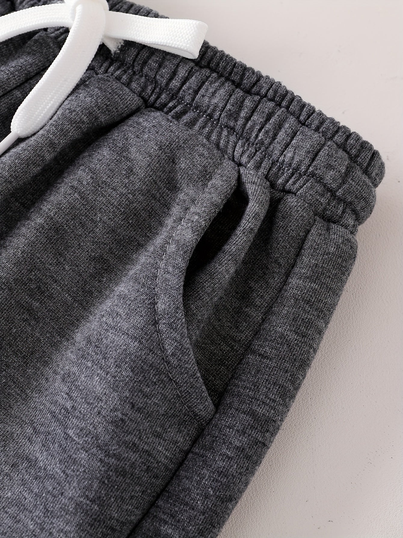 6 Pairs Of Children's Sportswear Pants, Mainly In Black And Gray Tones, with Different Trendy Words And Patterns Printed On The Pant Legs, Featuring An Overall Design Full Of Street Coolness, Suitable for Various Styles Of To